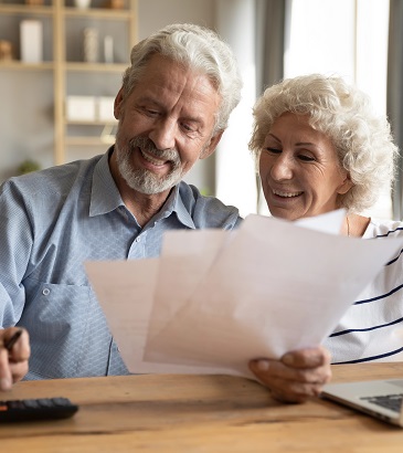 starsi kobieta i mężczyzna zadowolenia przyglądaja się pismu, w tle kalkulator